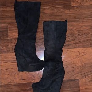 Black suede knee high boots.